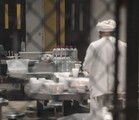 File - A detainee prepares for the mid-day meal at Joint Task Force (JTF) Guantanamo.