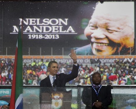 In this Dec. 10, 2013, photo, President Barack Obama waves as he arrives to speak at the memorial service for former South African president Nelson Mandela at the FNB Stadium in the Johannesburg, South Africa township of Soweto. The Nelson Mandela eulogized to the world by Obama as "a giant of history" and the "last great liberator of the 20th century," seemed a different person from the one the United States held at arm's length, to put it diplomatically, for much of his life and career.