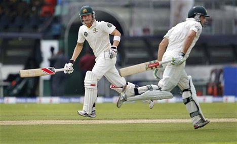 Australia's captain Michael Clarke, left, and batsman Shaun Marsh run between wickets during the first day play of the third cricket test match against Sri Lanka in Colombo, Sri Lanka, Friday, Sept. 16, 2011.