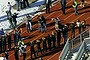 Students of Arapahoe High School in Centennial, Colorado, line up to be checked by police at a running track after a shooting at the school.