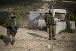 Israeli soldiers stand guard in Rosh Hanikra, Israel, near the border between northern Israel and Lebanon, Monday, Dec. 16, 2013. Israeli troops shot two Lebanese soldiers early on Monday.