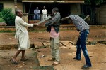 Muslim men organized in militias with machetes rough up a Christian man while checking him for weapons in the Miskine neighbourhood of Bangui, Central African Republic, Friday Dec. 13, 2013.