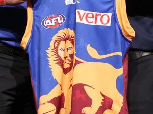 Top draft pick James Aish holds up the Brisbane Lions “Pad...