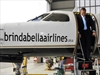 Tony Abbott leaves a Brindabella Airlines plane