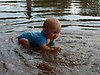 Baby swims with crocs