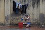 An Indian resident bathes on a roadside in New Delhi on December 22, 2013.