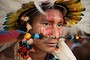 A Brazilian indigenous man of the Rikbaktsa tribe watches the bow and arrow competition during the XII International Games of Indigenous Peoples in Cuiaba, Mato Grosso state, Brazil on November 12, 2013.