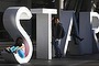 A tourist poses for pictures at the main sign of The Star Casino.