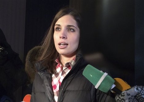 Nadezhda Tolokonnikova speaks to the media after leaving prison in Krasnoyarsk, Russia, Monday, Dec. 23, 2013.