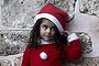 A Palestinian Greek Orthodox Christian girl dressed in Santa Claus stands outside the Saint Porfirios church in Gaza City.