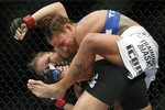 Liz Carmouche, top, grapples with Ronda Rousey during their UFC 157 women's bantamweight championship mixed martial arts match in Anaheim, Calif., Saturday, Feb. 23, 2013. Rousey won the first womens bout in UFC history, forcing Carmouche to tap out in the first round. (AP Photo/Jae C. Hong)