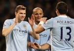 Manchester City's Edin Dzeko, left, celebrates with teammates Aleksandar Kolarov, right, and Vincent Kompany after scoring against Blackburn Rovers during their English Premier League soccer match at The Etihad Stadium, Manchester, England, Saturday, Feb. 25, 2012.