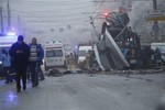 Ambulances line up a site of a trolleybus explosion, background, in Volgograd, Russia Monday, Dec. 30, 2013.