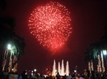 Filipinos gather in a park watching fireworks that lit up the sky as they welcomed in the new year Friday, Jan. 1, 2010.