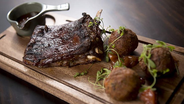 Slow-roasted cola lamb ribs with hush-puppies and peach relish.