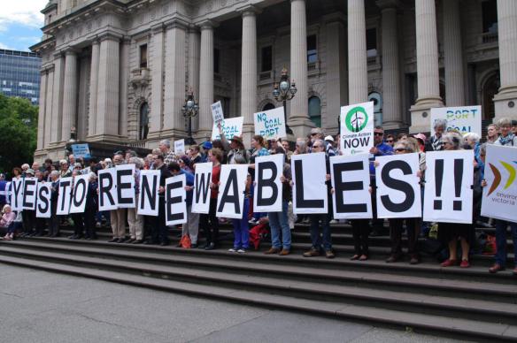 Placards spelling "Yes to Renewable"