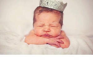 newborn baby wearing crown