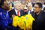 Soccer greats Pele and Eusebio hold a signed Brazil jersey in front of president of Brazil's soccer federation Jose Maria Marin before an international friendly soccer match between Brazil and Portugal in Foxborough, Massachusetts in September 2013.