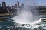 The town of Niagara Falls, Canada is seen past a cloud of mist rising over Horseshoe Falls, the largest of the Niagara Falls 