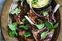 Barbecued lamb cutlets with spicy yoghurt sauce.