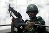 Uneven contest: a soldier keeps watch on polling day in Dhaka.