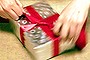 Woman wrapping a gift, present.