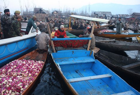 Famous Bollywood Actor Aamir Khan shares pleasantries with a group of Vegetable sellers in the Floating vegetable market in the World Famous Dal Lake in Srinagar on 09, February 2012.