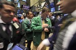 Traders swirl around fellow trader Kevin Coulter, second from right, as they work on the floor of the New York Stock Exchange Monday, April 5, 2010