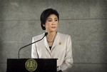 Thailand Prime Minister Yingluck Shinawatra pauses as she talks to media after attending a Cabinet meeting, in Bangkok, Thailand , Tuesday, Dec. 10, 2013. Shinawatra said Tuesday she would not resign ahead of national elections set for Feb. 2, despite opposition demands she step down as the caretaker head of government.