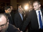 Iranian Foreign Minister Mohammad Javad Zarif, centre, arrives at his hotel in Geneva Switzerland, Friday evening Nov. 8, 2013, following his meeting with U.S. Secretary of State John Kerry and European Union foreign policy chief Catherine Ashton.