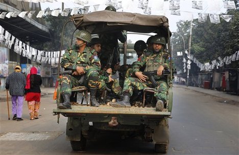 Bangladeshi army soldiers patrol on a street during the election, in Dhaka, Bangladesh, Sunday, Jan. 5, 2014.