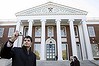 An unidentified man takes a photograph at the Harvard Business School in Boston, Massachusetts. The city has a history of innovation.