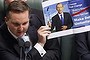 Shadow Treasurer Chris Bowrn displays an altered election pledge with Opposition Leader Bill Shorten during question time in Parliament House Canberra on Thursday 5 December 2013. Photo: Andrew Meares