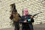 In this Sunday, Jan. 5, 2014, file photo, gunmen patrol during clashes with Iraqi security forces in Fallujah, Iraq.