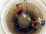 In this image released by the U.S. Air Force, a Malmstrom Air Force Base missile maintenance team removes the upper section of an ICBM at a Montana missile site