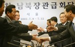 File - North Korean delegates, left, shake hands with South Korean counterparts during the minister-lever talks in Seoul on Thursday, July 10, 2003.