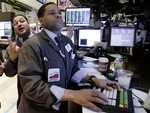 In this Nov. 3, 2010 photo, specialists Anthony Sherman, left, and Bernard Wheeler work on the floor of the New York Stock Exchange.