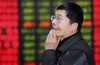 An investor reacts as he looks at the stock price monitor at a private securities company Tuesday, Jan. 13, 2009 in Shanghai, China. Chinese shares fell Tuesday on unease about a bleak outlook for corporate profits and declines on Wall Street and elsewhere in Asia. The benchmark Shanghai Composite Index dropped 1.95 percent, or 36.98 points, to close at 1863.37. (AP Photo/Eugene Hoshiko)