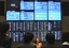 Freshmen listen to an explanation in front of an electric market board during their training at Tokyo Stock Exchange in Tokyo, Thursday, Apr. 9, 2009. The benchmark Nikkei 225 stock average increased 1.84 percent to 8,753.39 at the end of the morning session