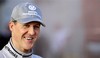 Mercedes GP Formula One driver Michael Schumacher of Germany smiles after a test session at the racetrack of Montmelo, near Barcelona, Spain, Friday, Feb 26, 2010.