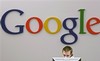 A Google receptionist works at the front desk in the company's office in this Oct. 2, 2006, file photo in New York. Google announces a change in its privacy policy that will anonymize the data stockpiled from Internet Protocol addresses and cookies after an 18 to 24 month period.