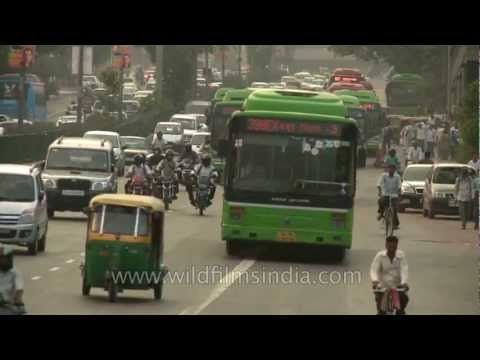 Chaotic traffic moves along a busy road in New Delhi