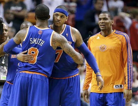 New York Knicks guard J.R. Smith (8) and forward Carmelo Anthony (7) congratulate each other after the Knicks defeated the Miami Heat 102-90 in an NBA basketball game, Tuesday, April 2, 2013 in Miami. Anthony tied his career high with 50 points. (AP Photo/Wilfredo Lee)