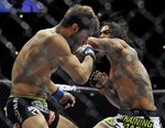 Benson Henderson right, punches Josh Thomson left, during the main event of the UFC mixed martial arts event in Chicago, Saturday, Jan., 25, 2014. (AP Photo/Paul Beaty)