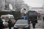 Military vehicles surround a wreckage of a trolleybus, in Volgograd, Russia, Monday, Dec. 30, 2013.