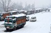 A queue stranded trucks on the Srinagar-Jammu National Highway  at Qazigund 80 kms From Srinagar on Thursday 09, Januray 2014. Srinagar-Jammu national highway was closed on Thursday after fresh snowfall in Bannihal and Patnitop sectors of the over 300-kilometre long road in Jammu and Kashmir.