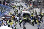 Medical workers aid injured people at the finish line of the 2013 Boston Marathon following an explosion in Boston