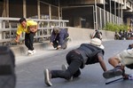 Anti-government protesters scatter while under fire in Bangkok, Thailand, Saturday, Feb. 1, 2014.