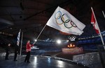 Vancouver Mayor Gregor Robertson, right, waves the Olympic flag next to mayor of Sochi Anatoly Pakhomov, left, and International Olympic Committee (IOC) President Jacques Rogge, center, during the closing ceremony for the Vancouver 2010 Olympics in Vancouver, British Columbia, Sunday, Feb. 28, 2010