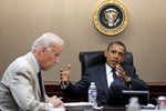 File - President Barack Obama and Vice President Joe Biden meet with his national security staff in the Situation Room of the White House, June 20, 2011.